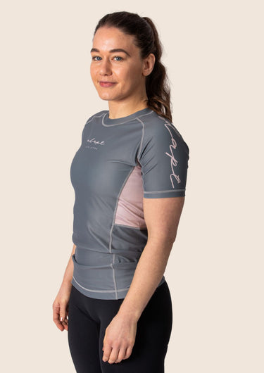 Women’s ash‑rose technical BJJ rashguard; muted pink on grey colour with underarm mesh ventilation.
