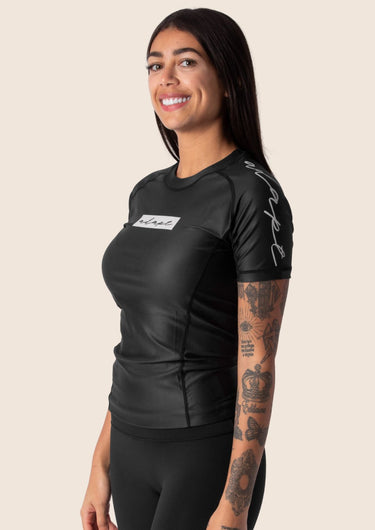 Women’s original BJJ rashguard in black, minimalistic design, 100% IBJJF legal.