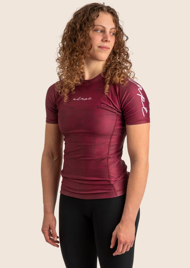 Women’s prism BJJ rashguard in maroon with geometric prism design; short sleeves.