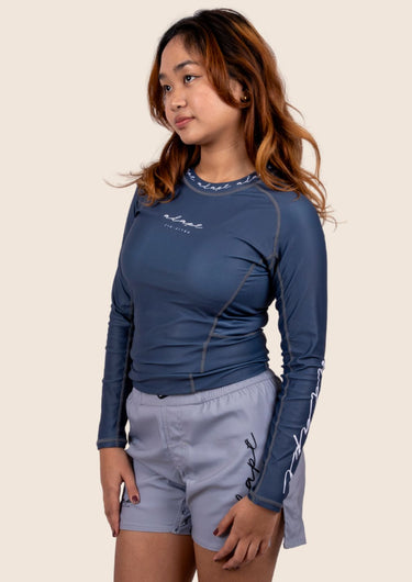 Women’s long‑sleeved technical BJJ rashguard in Blue, featuring four‑way stretch and mesh ventilation. Unique womens fit.