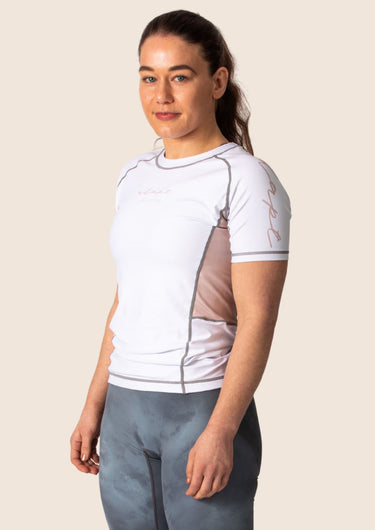 Women’s snow rose technical BJJ rashguard in white and pink, featuring four‑way stretch and mesh ventilation. Unique womens cut.