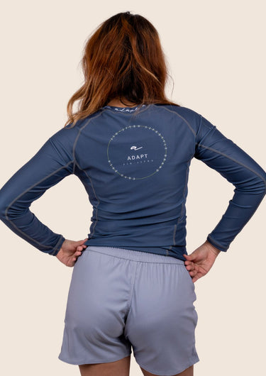 Women’s long‑sleeved technical BJJ rashguard in Blue, featuring four‑way stretch and mesh ventilation. Unique womens fit.