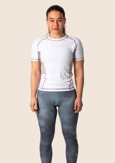Women’s snow rose technical BJJ rashguard in white and pink, featuring four‑way stretch and mesh ventilation. Unique womens cut.