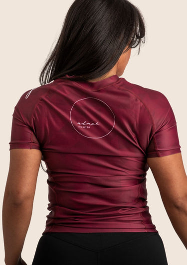 Women’s prism BJJ rashguard in maroon with geometric prism design; short sleeves.