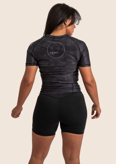 Women’s Prism BJJ rashguard in black Jacquard Lycra with geometric prism pattern, short sleeves, compression fit.