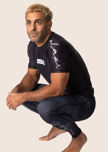 Men’s original BJJ rashguard in black, minimalistic design, 100% IBJJF legal.