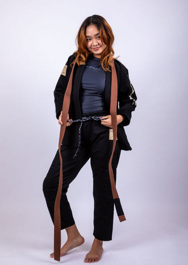 Women’s signature BJJ gi in black with 450 GSM jacket and 10 oz rip‑stop pants; premium embroidered design.