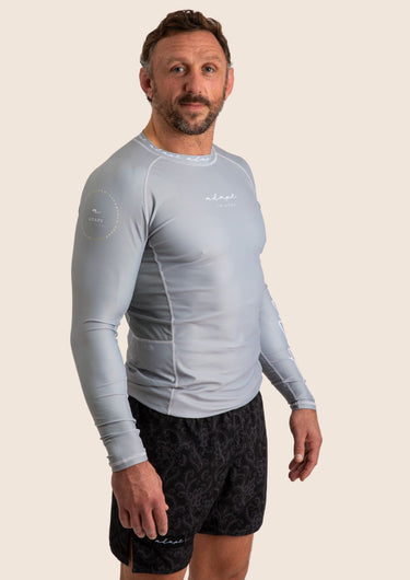 Men’s long‑sleeved technical BJJ rashguard in Silver, featuring four‑way stretch and mesh ventilation.