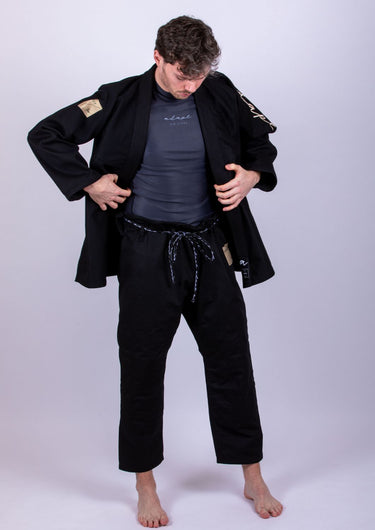 Men’s signature BJJ gi in black with 450 GSM jacket and 10 oz rip‑stop pants; premium embroidered design.