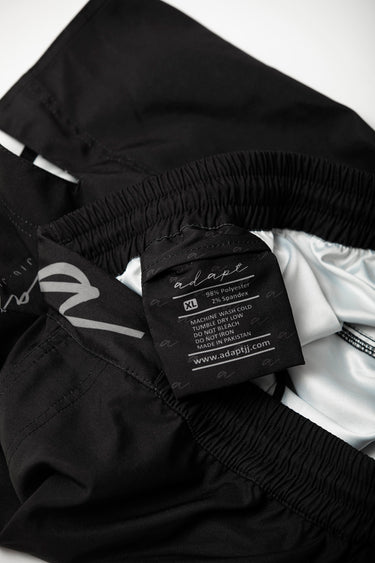 Unisex Jiu‑Jitsu training shorts in solid black; lightweight fabric with adjustable waistband