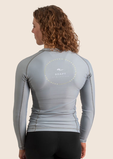 Women’s long‑sleeved technical BJJ rashguard in Silver, featuring four‑way stretch and mesh ventilation. Unique womens fit.