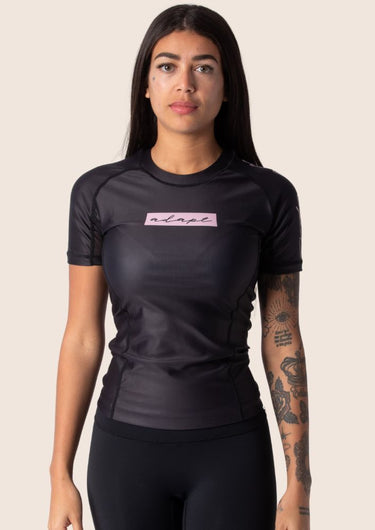 Women’s original BJJ rashguard with pink and black colour‑block design; tailored female fit.
