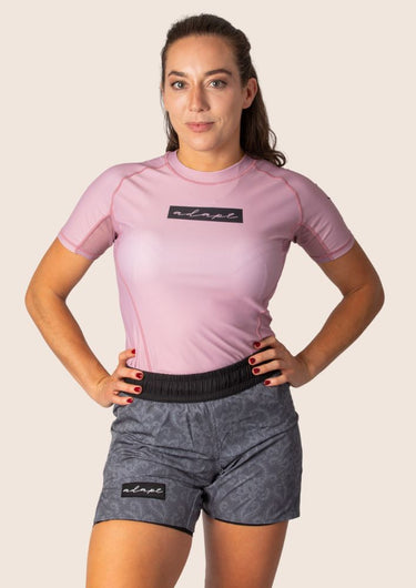 Women’s original BJJ rashguard in pink, featuring four‑way stretch and mesh ventilation. Unique womens fit.