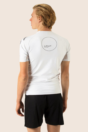 Men’s original BJJ rashguard in white, minimalistic design, 100% IBJJF legal.