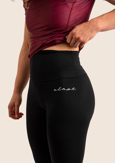 Women’s high‑waisted BJJ training leggings in black with minimalist design; squat‑proof four‑way stretch.