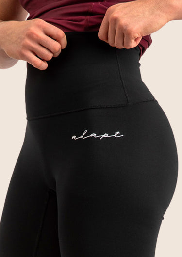 Women’s high‑waisted BJJ training leggings in black with minimalist design; squat‑proof four‑way stretch.