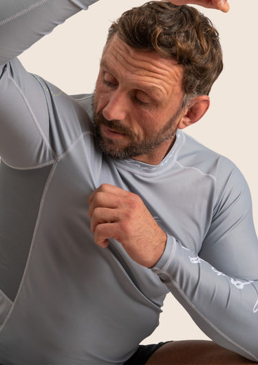 Men’s long‑sleeved technical BJJ rashguard in Silver, featuring four‑way stretch and mesh ventilation.