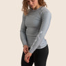 Women’s long‑sleeved technical BJJ rashguard in Silver, featuring four‑way stretch and mesh ventilation. Unique womens fit. 