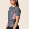 Women’s ash‑rose technical BJJ rashguard; muted pink on grey colour with underarm mesh ventilation.