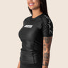 Women’s original BJJ rashguard in black, minimalistic design, 100% IBJJF legal.