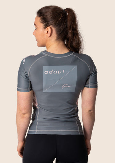 Women’s ash‑rose technical BJJ rashguard; muted pink on grey colour with underarm mesh ventilation.
