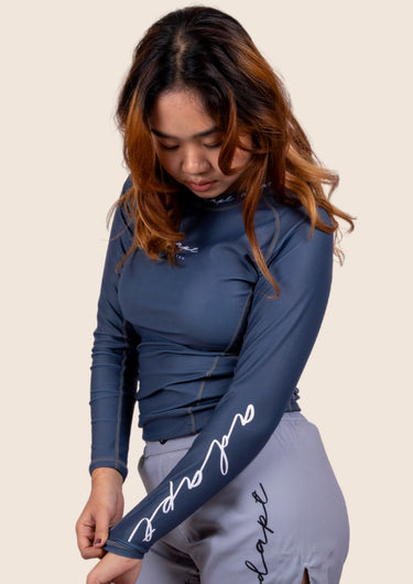 Women’s long‑sleeved technical BJJ rashguard in Blue, featuring four‑way stretch and mesh ventilation. Unique womens fit. 