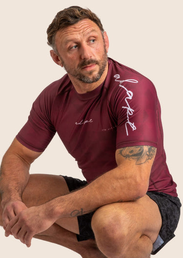 Men’s Prism BJJ rashguard in deep maroon Jacquard Lycra with geometric prism pattern, short sleeves, compression fit. 