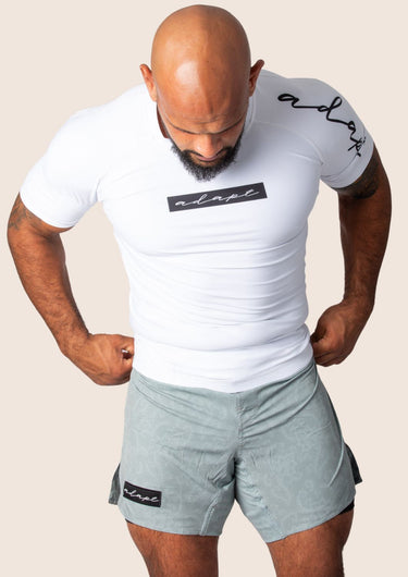 Men’s original BJJ rashguard in white, minimalistic design, 100% IBJJF legal. 