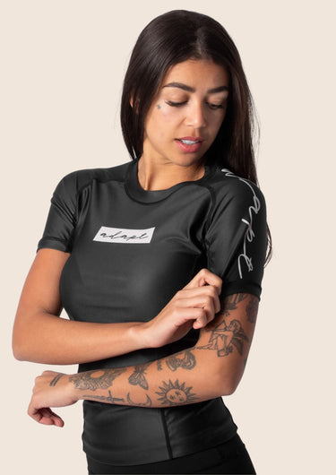 Women’s original BJJ rashguard in black, minimalistic design, 100% IBJJF legal.