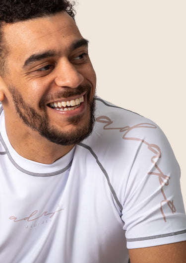 Men’s snow rose technical BJJ rashguard in white and pink, featuring four‑way stretch and mesh ventilation.