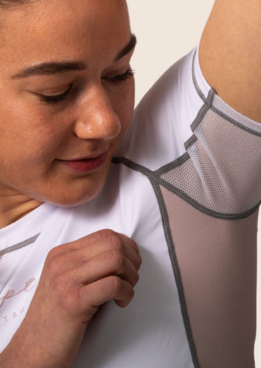 Women’s snow rose technical BJJ rashguard in white and pink, featuring four‑way stretch and mesh ventilation. Unique womens cut. 