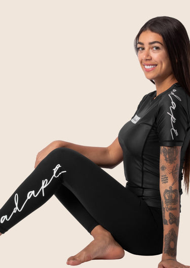 Women’s original BJJ rashguard in black, minimalistic design, 100% IBJJF legal.