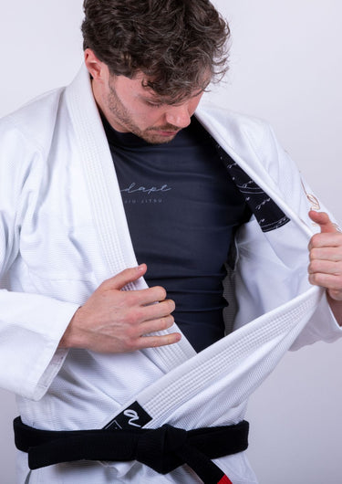 Men’s signature BJJ gi in white with 450 GSM jacket and 10 oz rip‑stop pants; premium embroidered design.