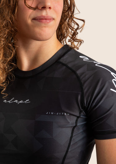 Women’s Prism BJJ rashguard in black Jacquard Lycra with geometric prism pattern, short sleeves, compression fit. 