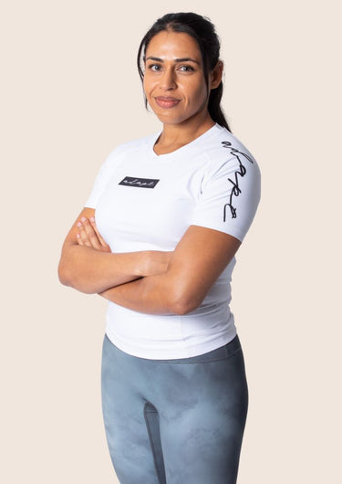 Women’s original BJJ rashguard in white, minimalistic design, 100% IBJJF legal.