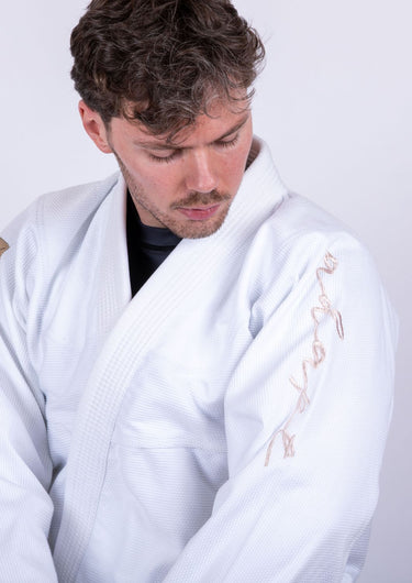 Men’s signature BJJ gi in white with 450 GSM jacket and 10 oz rip‑stop pants; premium embroidered design.