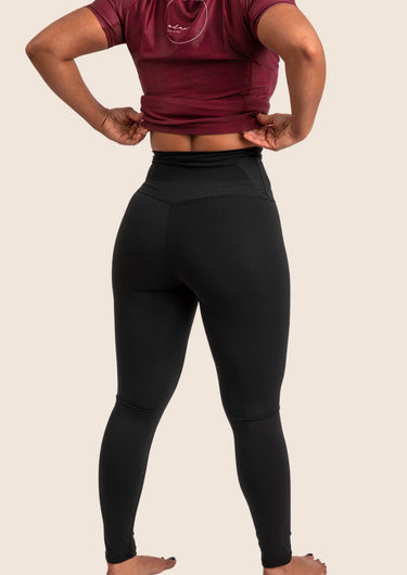 Women’s high‑waisted BJJ training leggings in black with minimalist design; squat‑proof four‑way stretch.