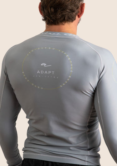 Men’s long‑sleeved technical BJJ rashguard in Silver, featuring four‑way stretch and mesh ventilation.