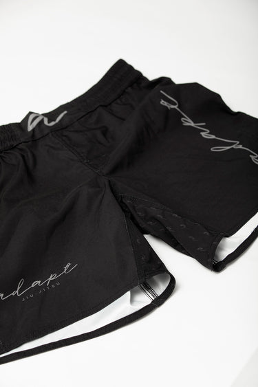 Unisex Jiu‑Jitsu training shorts in solid black; lightweight fabric with adjustable waistband