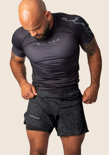 Unisex Jiu-Jitsu dual‑layer combination shorts with black paisley pattern; built‑in compression liner; adjustable fit.