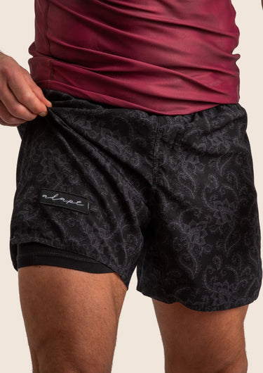 Unisex Jiu-Jitsu dual‑layer combination shorts with black paisley pattern; built‑in compression liner; adjustable fit.