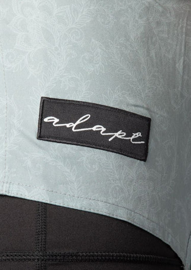 Unisex dual‑layer combination shorts with sage green paisley pattern; built‑in Lycra liner; secure fit.