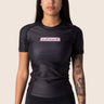 Women’s original BJJ rashguard with pink and black colour‑block design; tailored female fit.