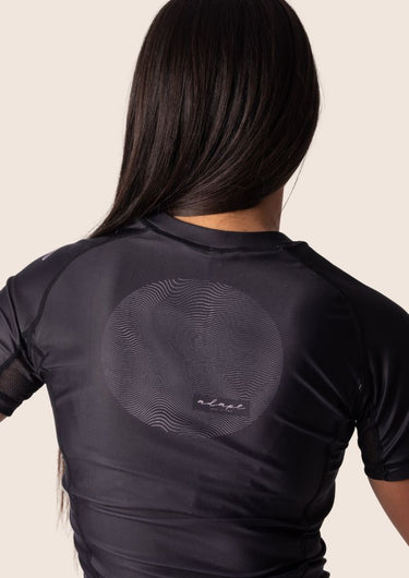 Women’s original BJJ rashguard with pink and black colour‑block design; tailored female fit.
