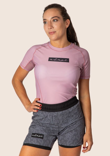 Women’s original BJJ rashguard in pink, featuring four‑way stretch and mesh ventilation. Unique womens fit. 