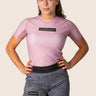 Women’s original BJJ rashguard in pink, featuring four‑way stretch and mesh ventilation. Unique womens fit. 