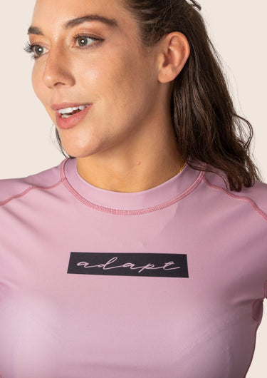 Women’s original BJJ rashguard in pink, featuring four‑way stretch and mesh ventilation. Unique womens fit. 