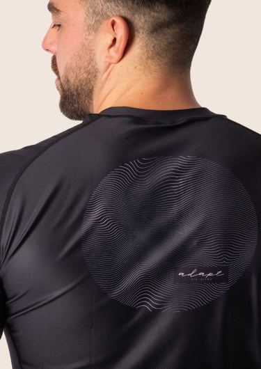 Men’s original BJJ rashguard with pink geometric design on black background.