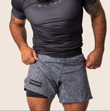 Unisex Jiu Jitsu dual‑layer combination shorts featuring dark grey paisley print; internal compression layer; flexible fit.