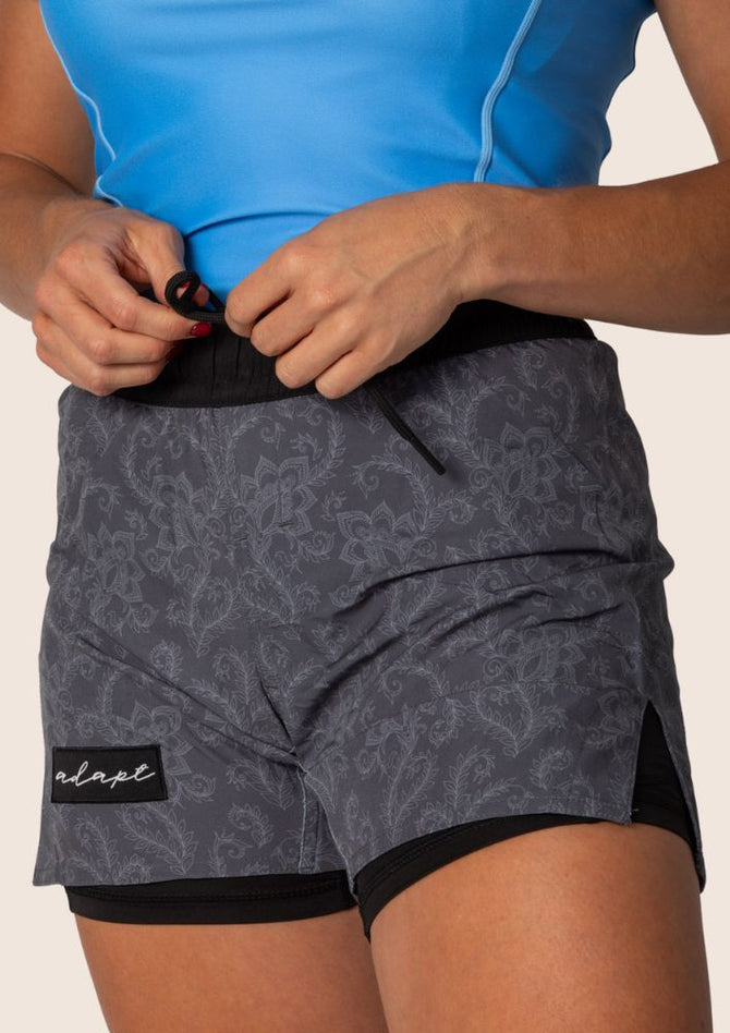 Unisex Jiu Jitsu dual‑layer combination shorts featuring dark grey paisley print; internal compression layer; flexible fit.
